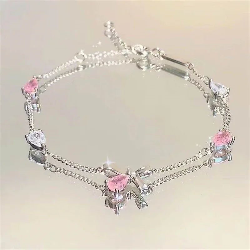 Seasonal bracelet set photographed under natural light, emphasizing gold shine and charm details.