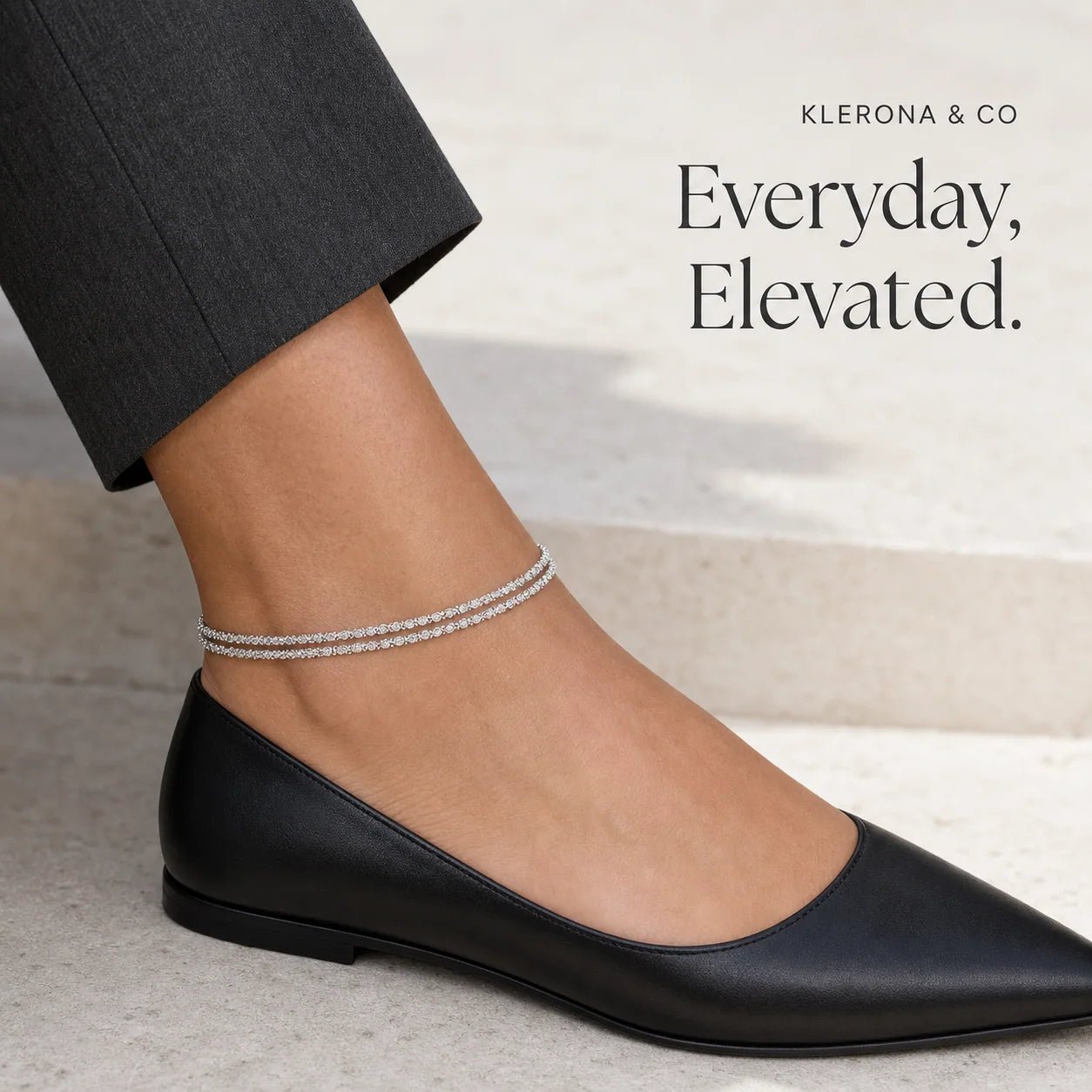 Silver double-strand anklet styled with a black flat